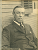 Black and white portrait of Woodrow Wilson, seated outdoors, at the time of his candidacy for Governor of new Jersey.