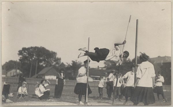A photograph of Ina Giddings pole-jumpling; University of Nebraska campus, c. 1900.