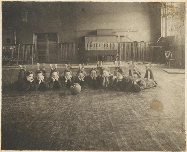 A photograph of women's basketball team in the gym,  c. 1900.