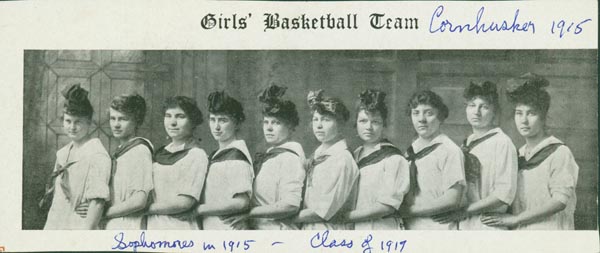 black and white photo of the girls basketball team, Cornhusker 1915; photo shows ten girls in white uniforms from the waist up