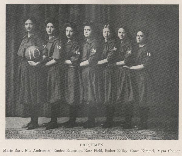 page 201 of 1907 yearbook; black and white image of freshmen basketball team; seven women, facing left, linked by left arm, woman on far left holding basketball