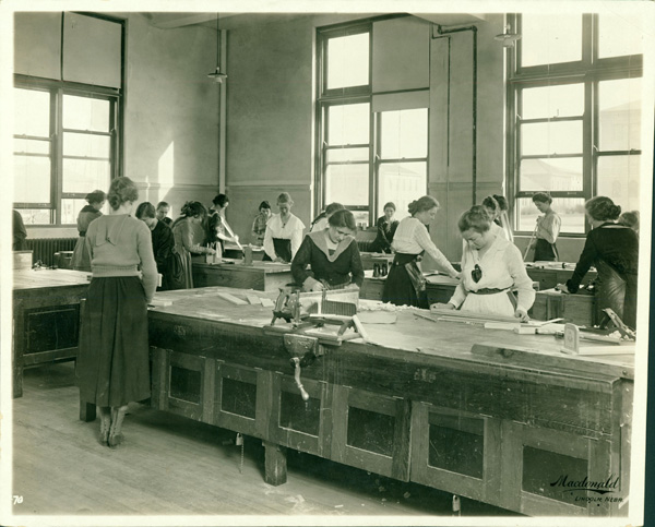 A photograph of women in an early wood shop.