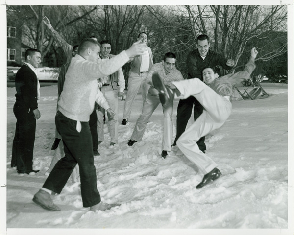 Members of Sigma Alpha Mu play outside of their house during a snowday in 1955. 
